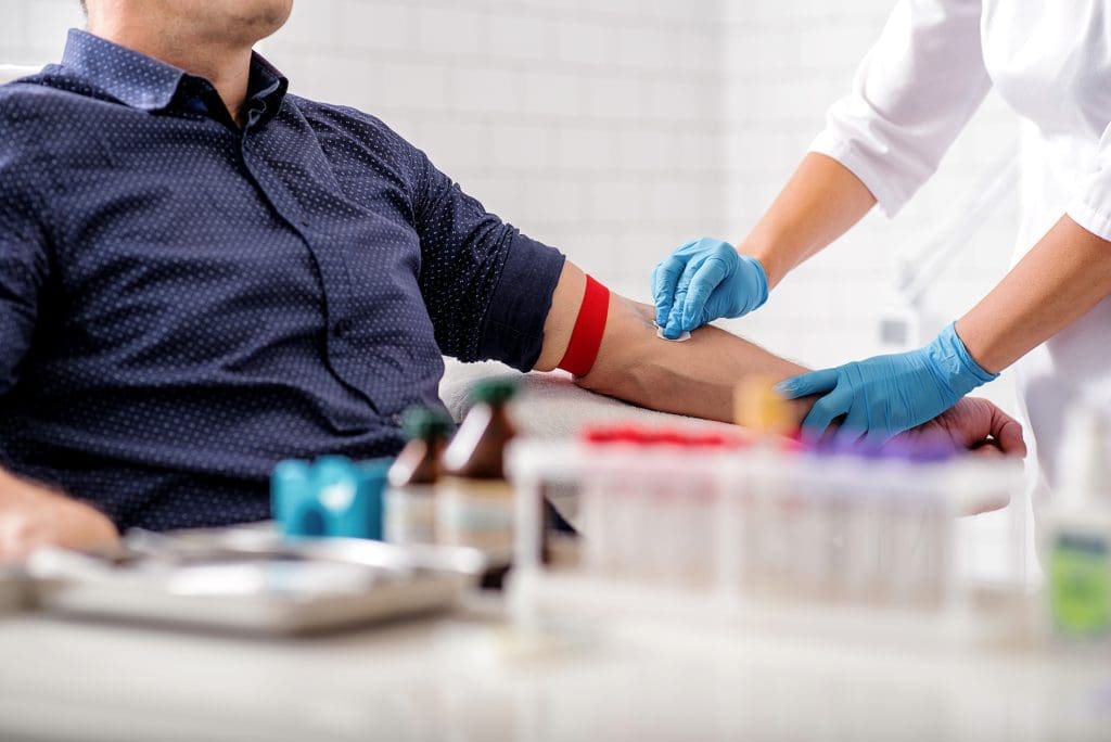 male patient having blood drawn